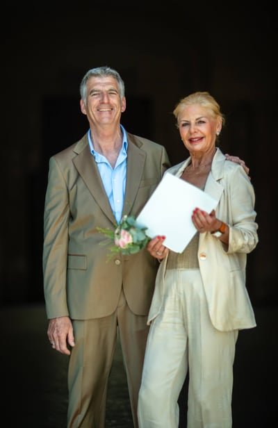 a man and woman standing next to each other on their wedding day 