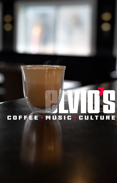 product image of a latte in a clear glass with Elvio's Coffee text in the image