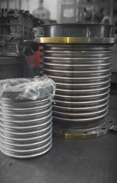 a stack of metal plates with a large metal object