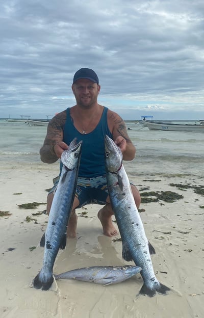 Angler holding an impressive Barracudas caught off the coast of Zanzibar