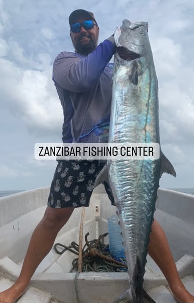 Angler holding an impressive King Mackerel caught off the coast of Zanzibar