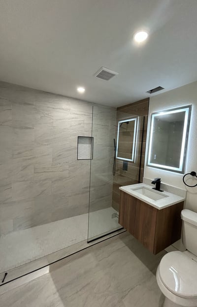 Bathroom renovation in Kissimmee with walk-in shower, ceramic tile, and modern vanity — remodel by F