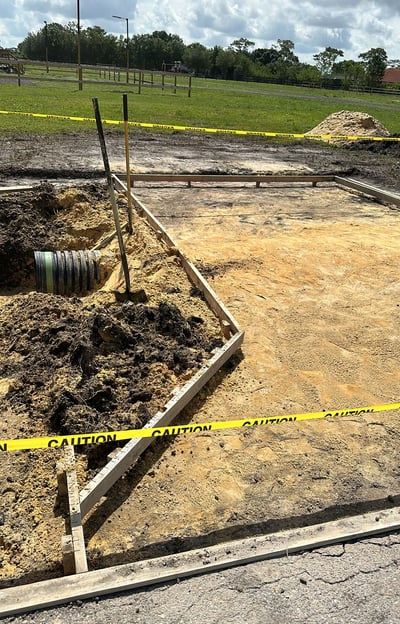 Residential driveway installation using pavers and compacted gravel base — expert exterior remodelin