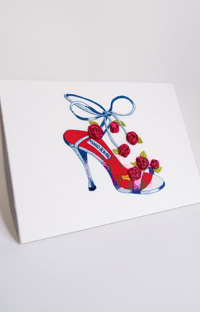 a greeting card with a red shoe with a shoelaced shoe