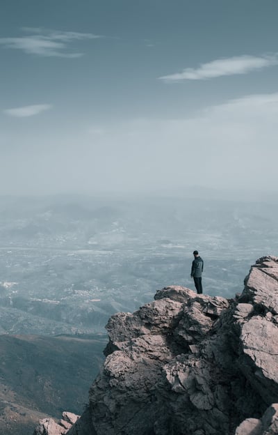 a person standing on a mountain top