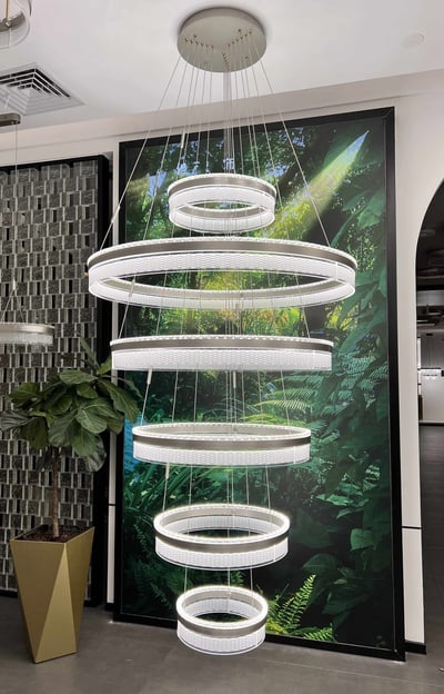 a large white circular light fixture hanging from a ceiling