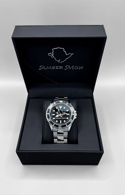 Amser Mon Anglesey black and white metal watch in an Anglesey branded box