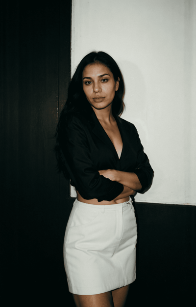 a woman in a black shirt and white skirt