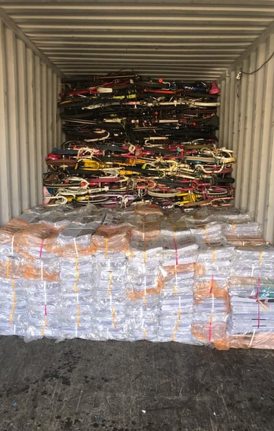 over issued newspaper and used bicycles loaded in a container for export to Afghanistan