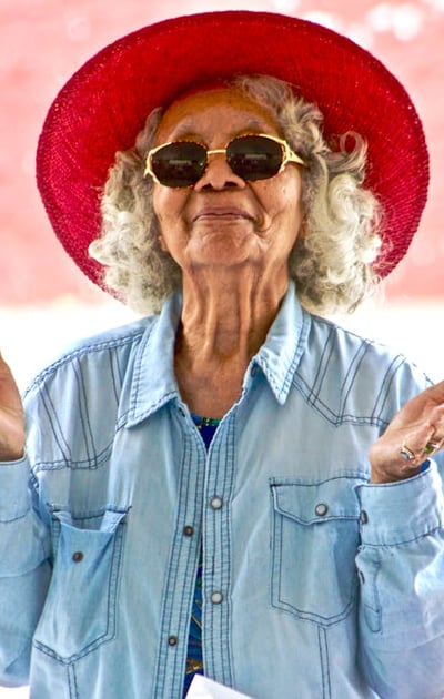 a woman in a red hat and sunglasses