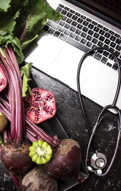 a laptop computer and a stethoscope on a table