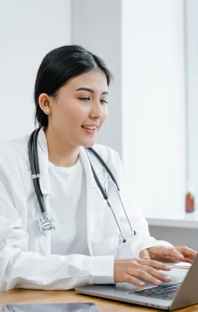 a woman in a white lab coat and a stethrobe