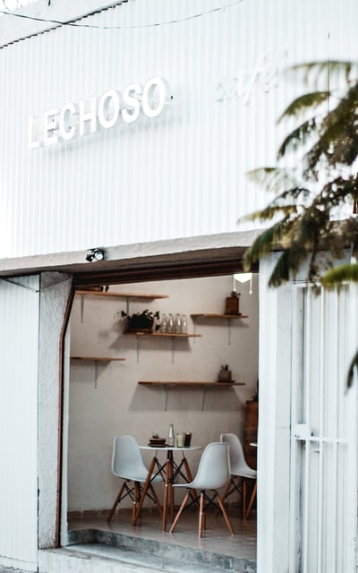 a white building with a table and chairs