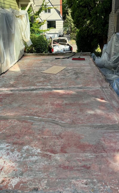 1930's Concrete paint and sealer that has chipped and failed to hold water out of the garage below.