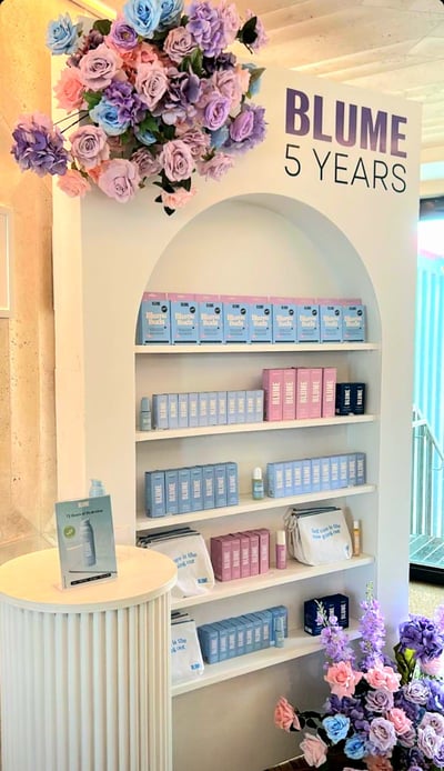 Champagne/ Treat wall of cosmetics products by Blume and flowers at Milky at the Stackt Market