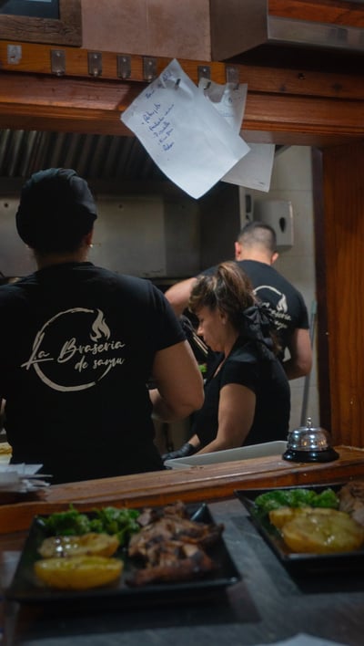 a man and woman in a restaurant kitchen