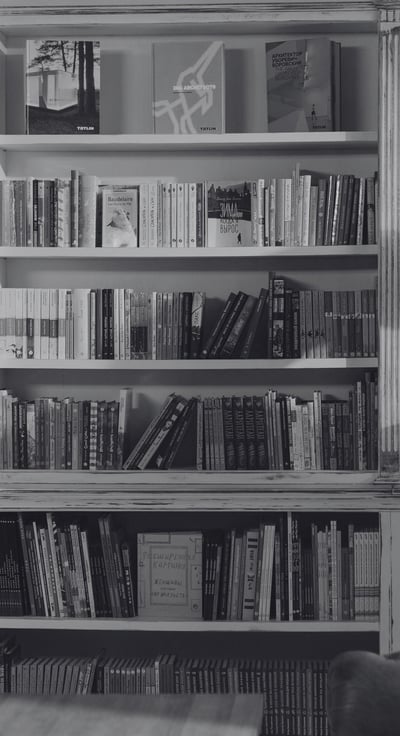 a single man and a single woman looking at books at a bookshop