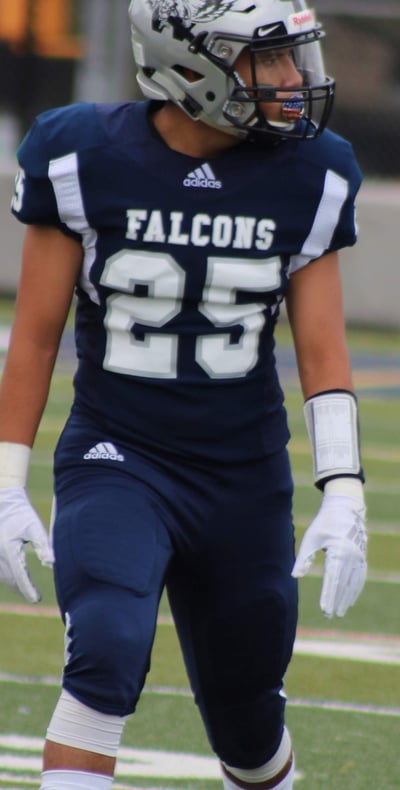 Picture of Isaac in a navy blue football jersey that reads "FALCONS" with the number 25.