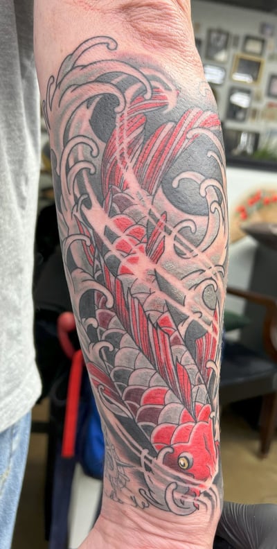a tattoo on the arm of a man's arm color tattoo koi fish