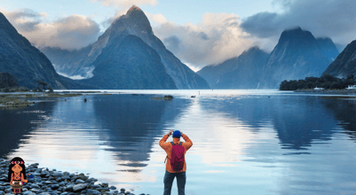 a person taking a picture of a lake in New Zealand