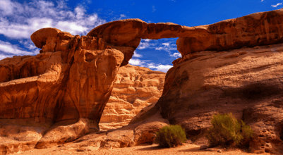 a rock formation in the Wadi Rum, Jordan with a blue sky and clouds
