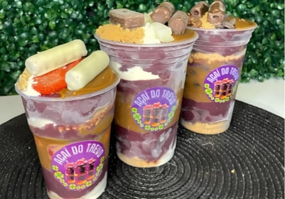 three cups of fruit and yogurt in a cupcake
