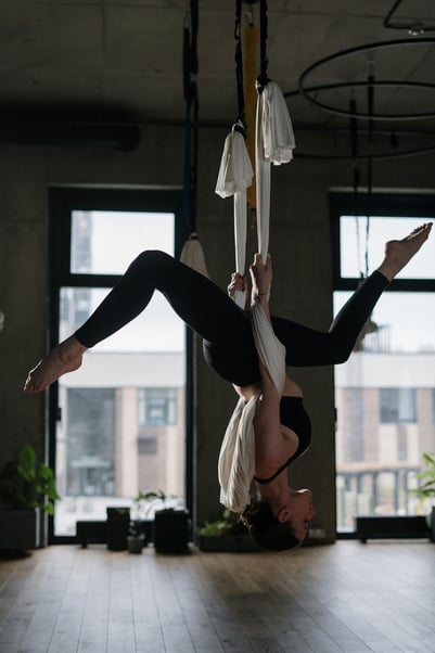 Girl hanging upside down on material