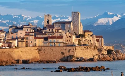 Antibes old town village on the sea with snowy mountains
