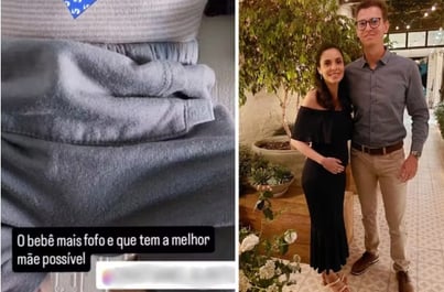 a man and woman standing in front of a heart shaped object