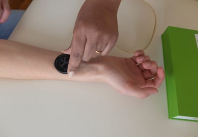 a person holding a redater on an arm