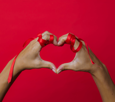 a person holding their hands in a heart shape