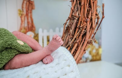 baby lying on a soft white blanket