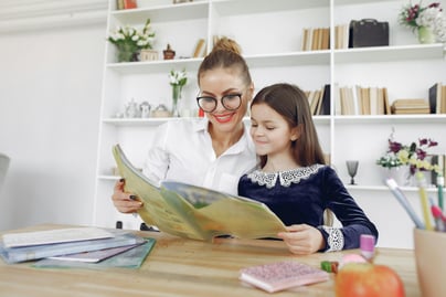 "Teacher providing guidance to a young student, ensuring clear understanding of the material."