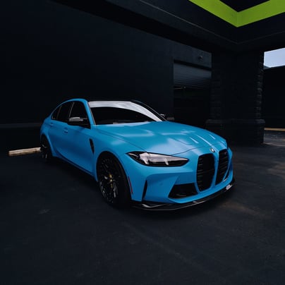 Electric blue BMW M3 Competition XDrive car photography at 704 Exotics in Charlotte, North Carolina.