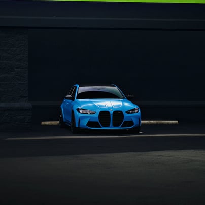 Electric blue BMW M3 Competition XDrive car photography at 704 Exotics in Charlotte, North Carolina.