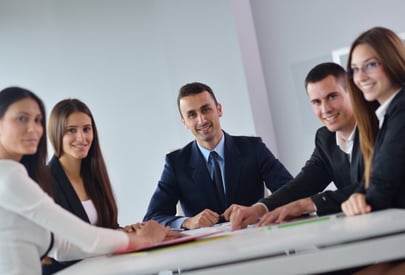 tailored training, a group of business people sitting at a table
