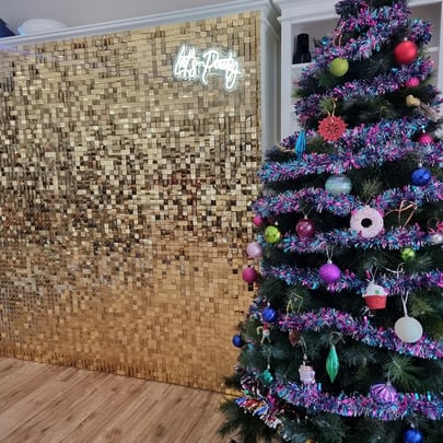 Gold shimmer wall with lets party neon behind xmas tree for work Christmas party in Brisbane.