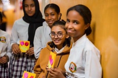 Sudanese schoolgirls holding handmade tulip cards