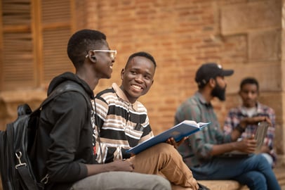 Sudanese students chatting with books