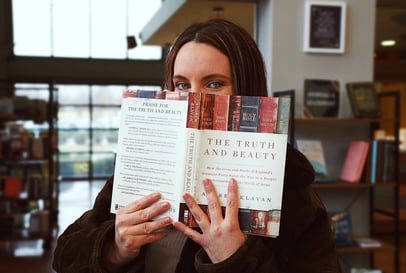 Ashleigh Marie model holding the book "The Truth and Beauty" in front of her face.