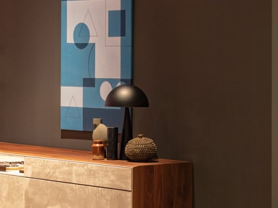 renovation done in a drawing room showcasing an antique wood table with lamp and accessories and art
