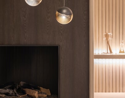 interior design example of renovated fireplace with a golden background wall and accent lighting