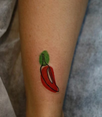 Abstract Red hot chilli tattoo with watercolor fill at Dudo's Tattoos Hyderabad