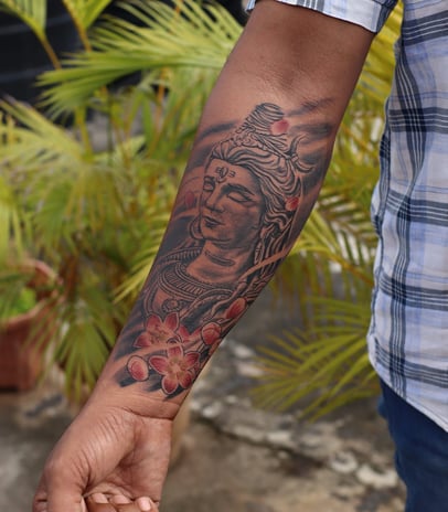 Black and grey Shiva tattoo in meditative pose by Dudo’s Tattoos in Hyderabad