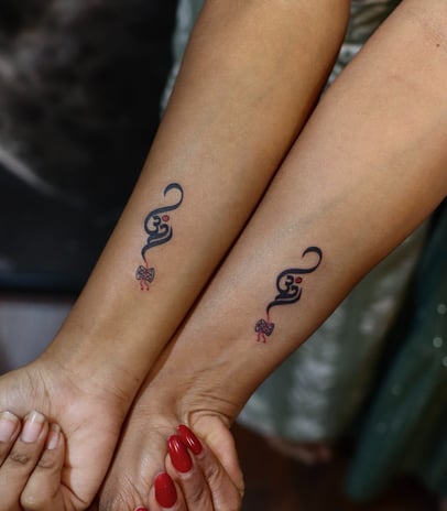 Sacred Om symbol tattoo in fine line style by Dudo’s Tattoo Studio Hyderabad