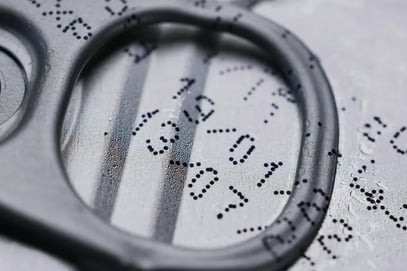 Close-up of expiration date printed on canned food top