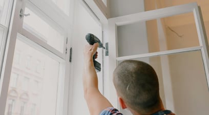 A man is holding a hammer and a hammer in his hand