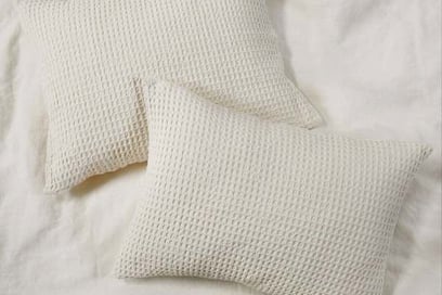 two pillows and a pillow on a bed