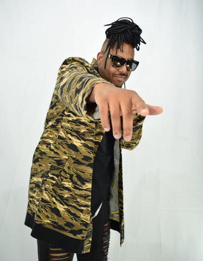 a man in a tiger print jacket pointing at the camera