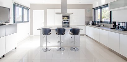 a kitchen with a bar stool and bar stools